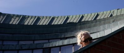 A person peers over the amphitheatre wall at Aalto Campus