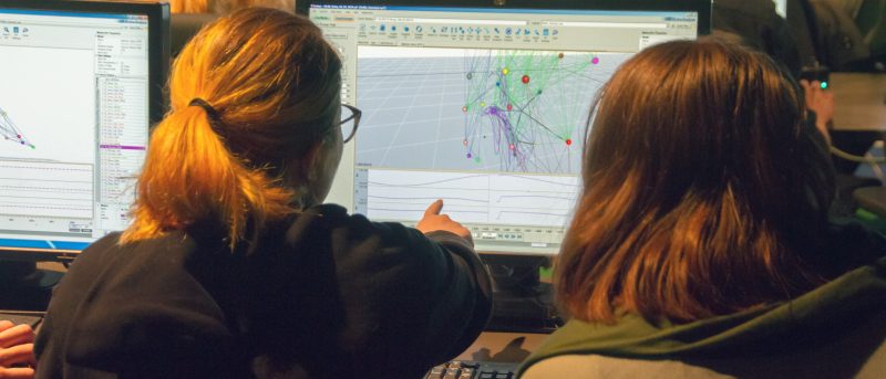 People using a computer showing data graphs