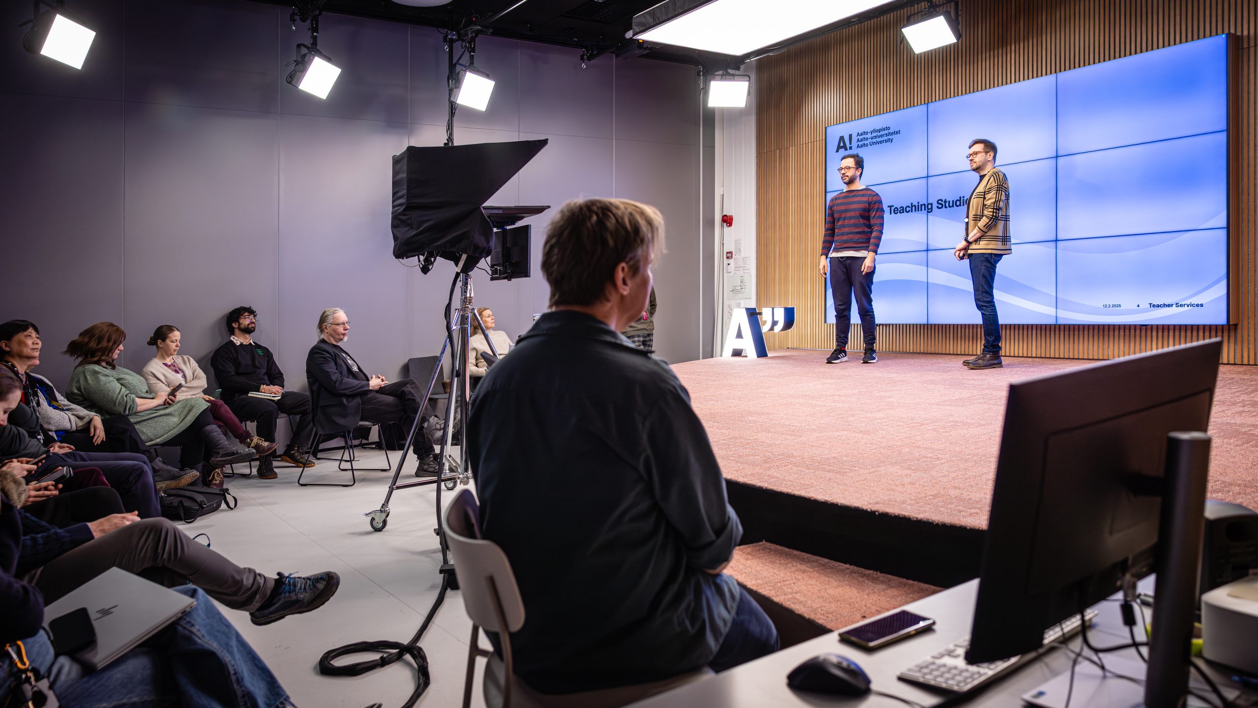 People watching two presenters on stage
